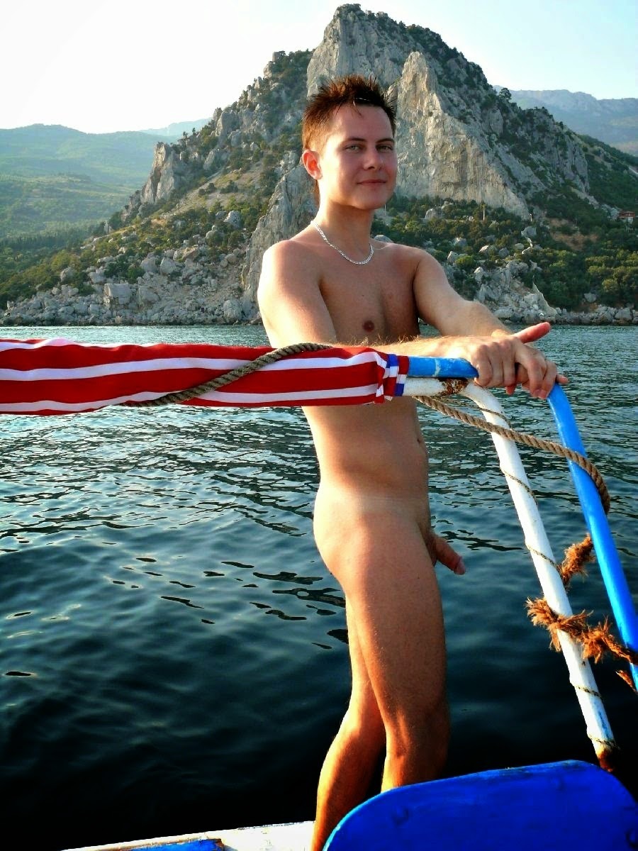 Cute nudist boy on a boat