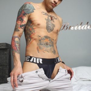 Tattooed boy with a big uncut cock