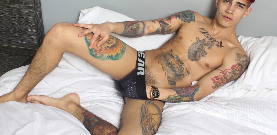 Tattooed boy with a big uncut cock